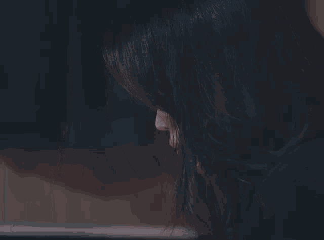 a close up of a woman 's face with long hair