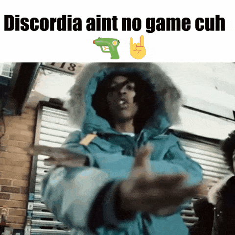 a man in a blue jacket with the words discordia aint no game cuh on the top