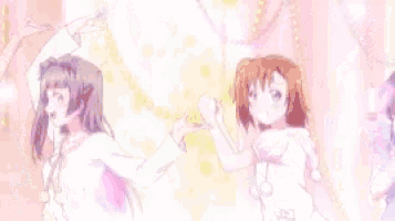 a group of anime girls are standing next to each other with their arms in the air .
