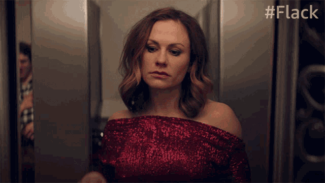 a woman in a red dress is standing in a hallway with the hashtag #flack