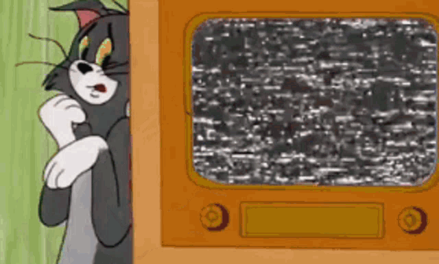 a cartoon cat is peeking out from behind a tv