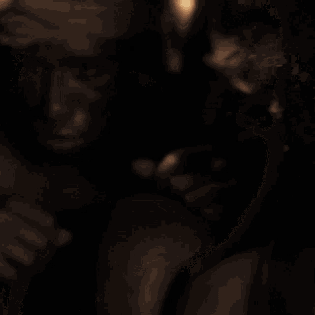 a close up of a woman 's face with a light shining on it