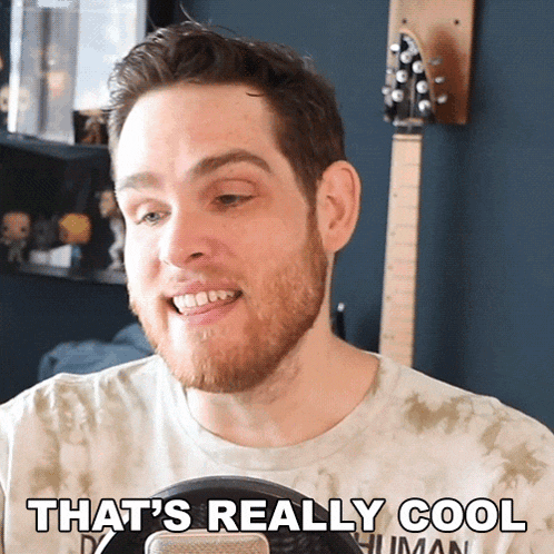 a man with a beard is smiling and says that 's really cool