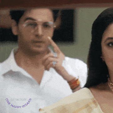 a man and a woman are looking at each other with a gif factory one happy insan logo