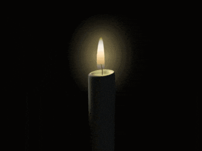 a candle with a picture of a person on it