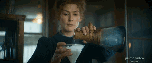 a woman is pouring liquid into a glass with the words prime video on the bottom right