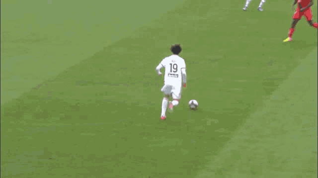 a soccer game is being played on a field with a banner that says ' bwin ' on it