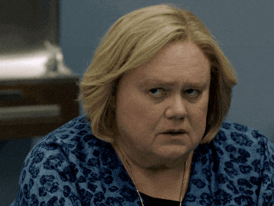 a woman with blonde hair is wearing a blue shirt