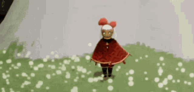 a person is standing in a field of flowers in a video game holding a red object .