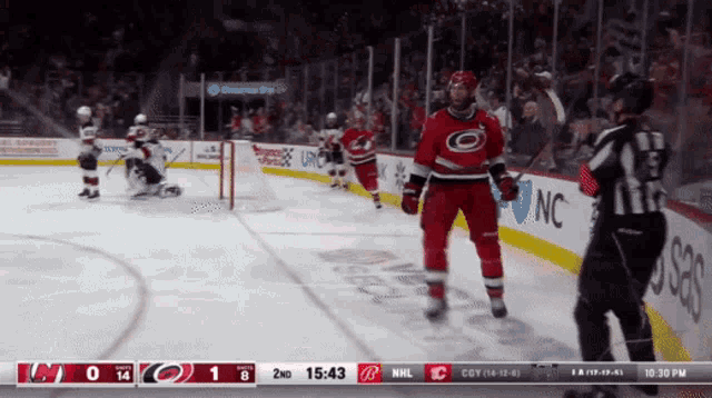 a hockey game is being played between the carolina hurricanes and the new york islanders