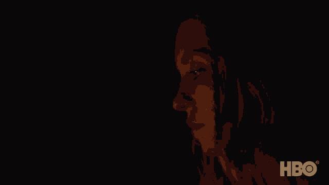a close up of a woman lighting a match with the hbo logo in the background