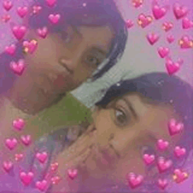 two girls are standing next to each other with pink hearts around them .