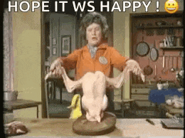 a woman is holding a dead chicken on a cutting board and says `` hope it ws happy '' .
