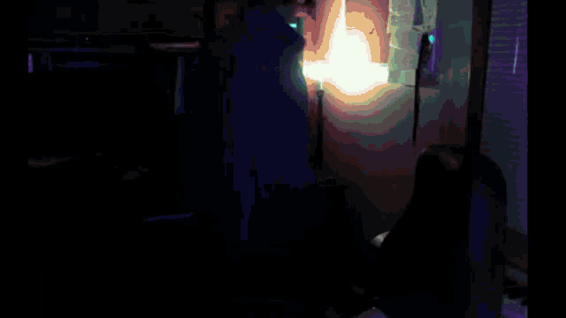 a man is standing in a dark room holding a light