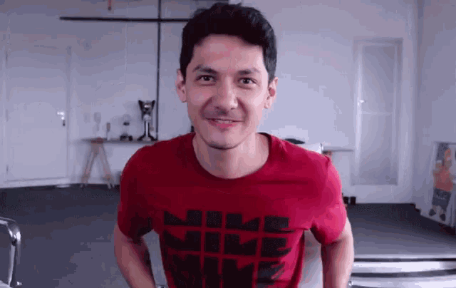 a man wearing a red shirt that says nike time on it