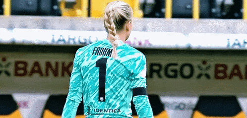 a female soccer player wearing a number one jersey