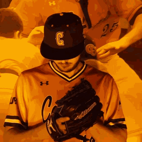 a baseball player wearing a mizuno glove