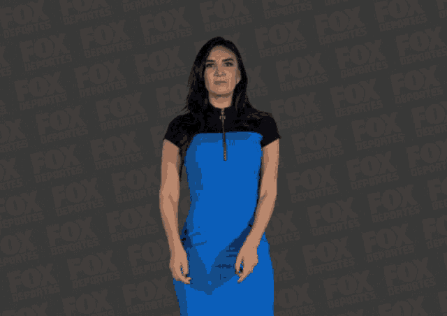 a woman in a blue dress stands in front of a fox advertisement