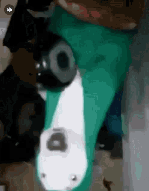 a close up of a green and white item with a hole in the middle of it .
