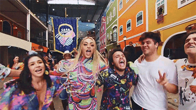 a group of people are standing next to each other in a colorful building .