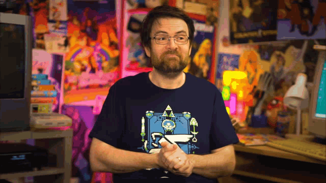 a man with glasses and a beard wears a shirt with a robot on it