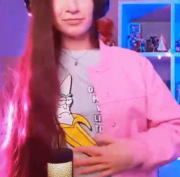 a woman wearing a pink jacket and a t-shirt with a banana on it
