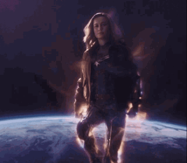 a woman in a captain america costume stands in front of a planet earth