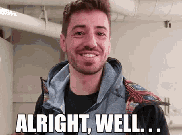 a man with a beard is smiling and says " alright well ... "
