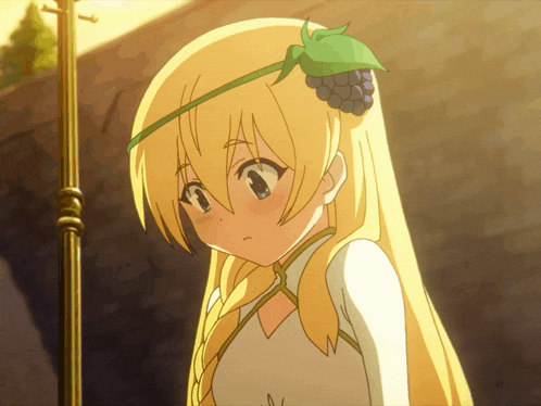 a girl with long blonde hair and a green headband with grapes on it