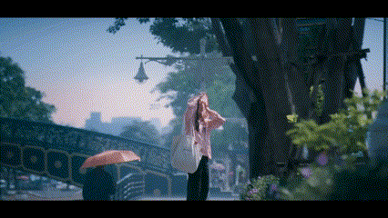 a woman holding an umbrella stands in the rain