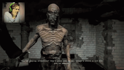 a man is playing a video game with a zombie in the background