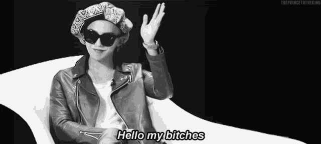 a black and white photo of a man wearing sunglasses and a leather jacket says hello my bitches .