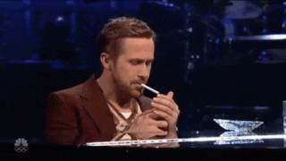 a man is smoking a cigarette on a stage .