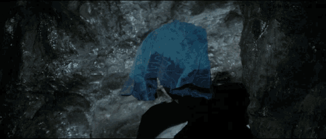 a man with blue hair is laying down in a pool of water