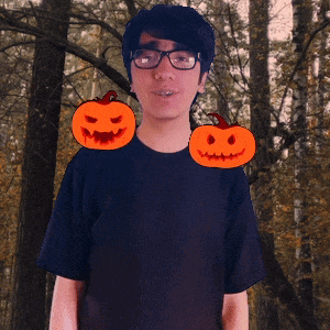 a man with glasses and two pumpkins on his shoulder
