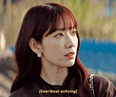 a close up of a woman 's face with the words heartbeat echoing above her