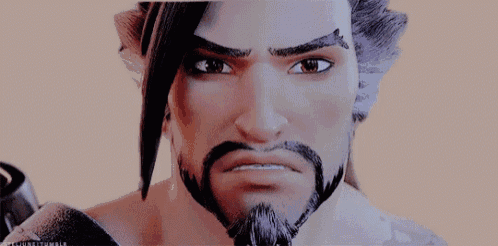 a close up of a cartoon character with a beard and a tattoo on his arm .