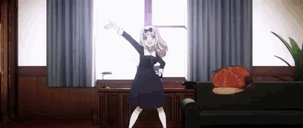 a girl in a black dress is dancing in a room