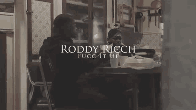 roddy ricch 's fucc it up video features a man sitting at a table