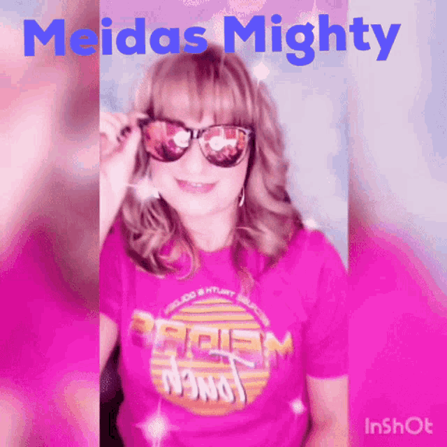 a woman wearing sunglasses and a pink shirt that says meidas mighty on it