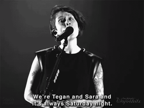 a woman singing into a microphone with the words we 're tegan and sara and it 's always saturday night below her