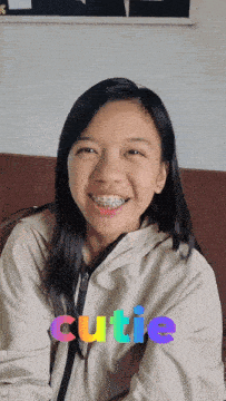 a girl with braces on her teeth is smiling and the word cutie is displayed above her