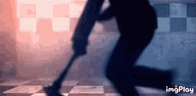 a silhouette of a man holding a gun in a dark room .