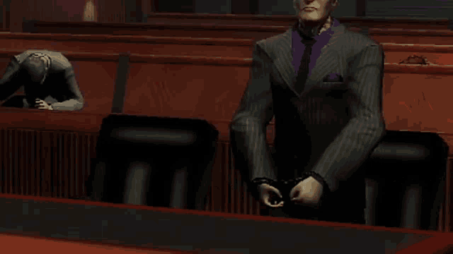 a man in a suit and tie stands in a courtroom
