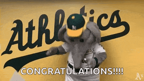 a mascot for the oakland athletics is standing in front of a sign that says congratulations !!!