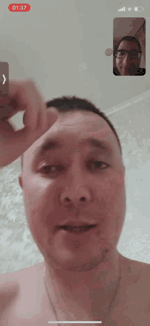 a man without a shirt is on a video call with another man with glasses