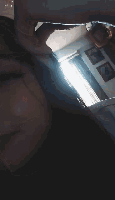 a close up of a woman 's face with a hand on her forehead