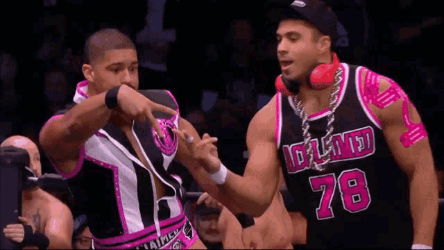 a man wearing a black and pink jersey with the number 78