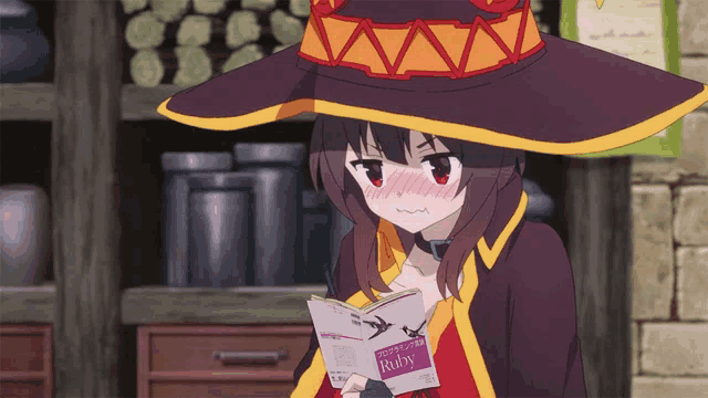 a girl wearing a witch hat is reading a book titled ruby