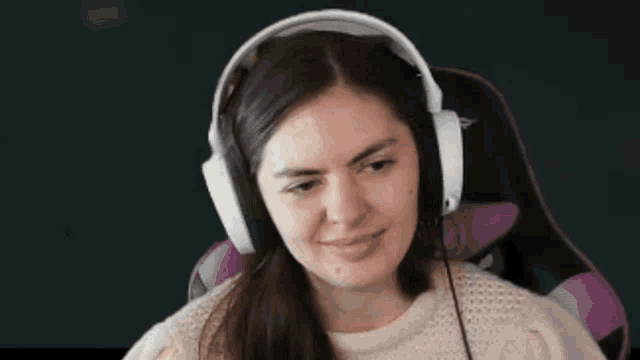 a woman wearing headphones and a microphone is smiling .